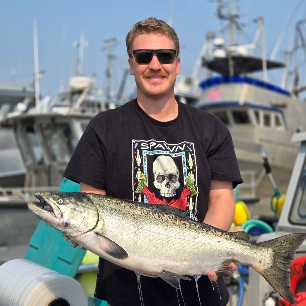 Slack Tide Fisheries holding a salmon